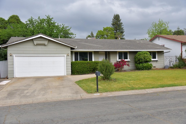 ranch-style home with concrete driveway, roof with shingles, a front yard, and a garage