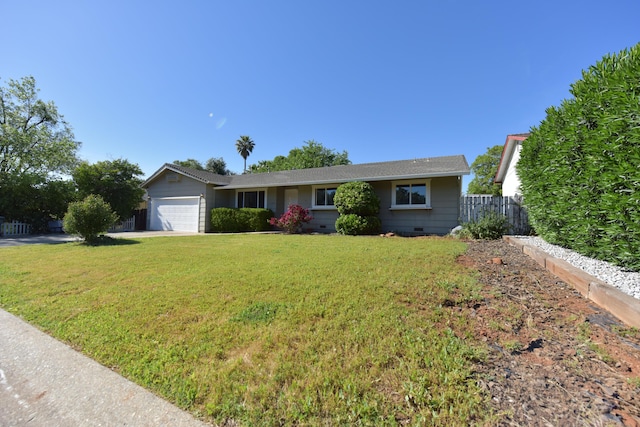 ranch-style house featuring fence, an attached garage, driveway, and a front yard