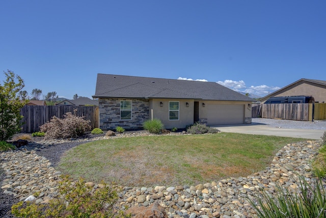 3503 Americana Way, Redding, CA 96003 - ranch-style home with stone siding, concrete driveway, fence, a garage, and a front yard