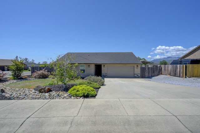3503 Americana Way, Redding, CA 96003 - ranch-style home with driveway, stone siding, fence, a garage, and stucco siding