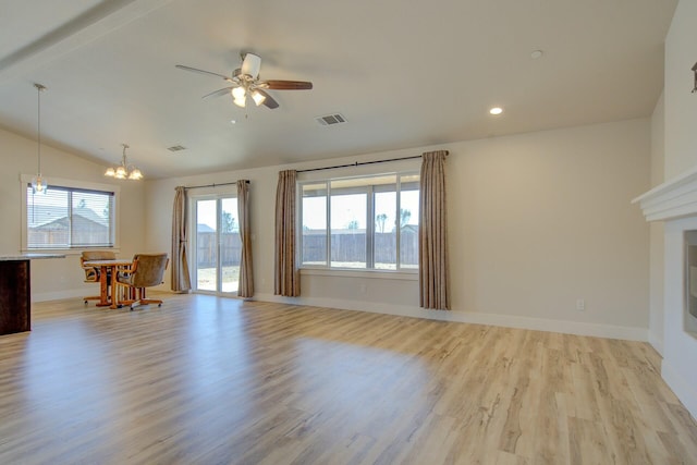 3503 Americana Way, Redding, CA 96003 - living area featuring ceiling fan with notable chandelier, light wood finished floors, baseboards, lofted ceiling, and visible vents