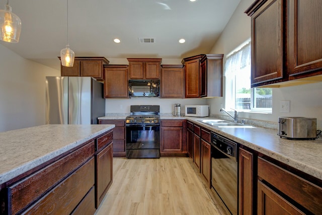 3503 Americana Way, Redding, CA 96003 - kitchen with light countertops, a sink, black appliances, and light wood-style flooring