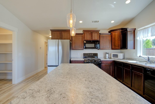 3503 Americana Way, Redding, CA 96003 - kitchen featuring a sink, black appliances, light wood-style flooring, light countertops, and visible vents