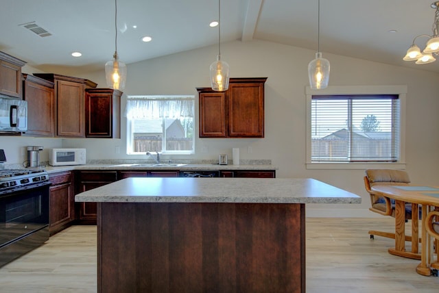 3503 Americana Way, Redding, CA 96003 - kitchen featuring visible vents, a sink, light wood-type flooring, black gas stove, and white microwave