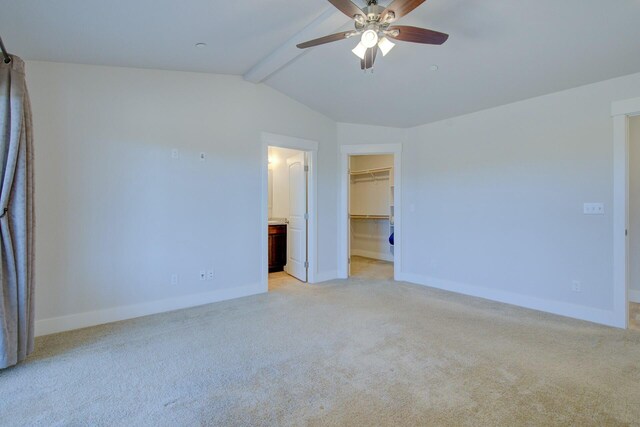 3503 Americana Way, Redding, CA 96003 - unfurnished bedroom featuring a walk in closet, baseboards, vaulted ceiling with beams, and light colored carpet