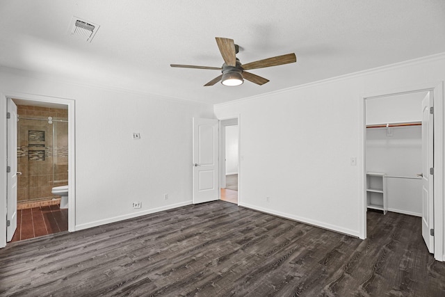 2633 Forest Ct, Redding, CA 96002 - unfurnished bedroom with crown molding, dark wood-style floors, connected bathroom, a walk in closet, and a ceiling fan