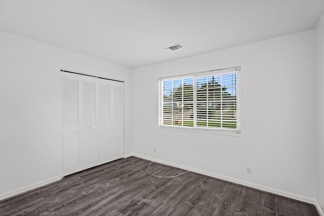 2633 Forest Ct, Redding, CA 96002 - unfurnished bedroom with dark wood-type flooring and a closet