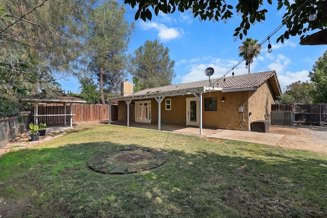 2633 Forest Ct, Redding, CA 96002 - rear view of property featuring a chimney, a fenced backyard, stucco siding, and a patio area