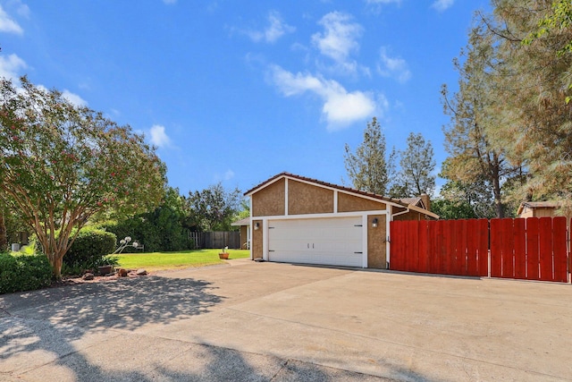 2633 Forest Ct, Redding, CA 96002 - view of property exterior featuring stucco siding, concrete driveway, a tiled roof, and a garage