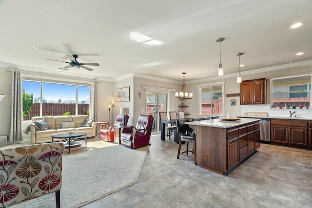 5538 Muir Peak Rd, Redding, CA 96002 - kitchen with a breakfast bar, decorative light fixtures, a sink, a center island, and open floor plan