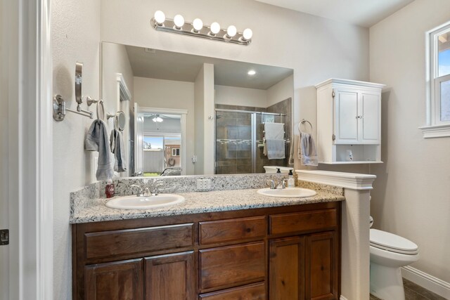 5538 Muir Peak Rd, Redding, CA 96002 - full bathroom featuring double vanity, toilet, a stall shower, and a sink