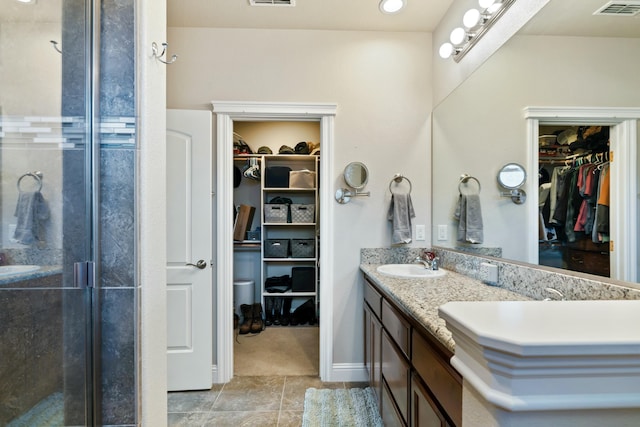 5538 Muir Peak Rd, Redding, CA 96002 - bathroom featuring visible vents, a stall shower, double vanity, and a sink
