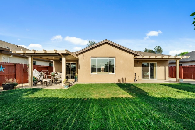 5538 Muir Peak Rd, Redding, CA 96002 - back of house with a lawn, stucco siding, a fenced backyard, and a patio area