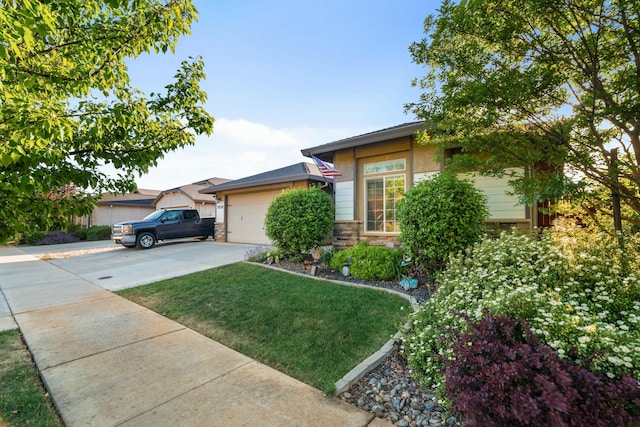 5538 Muir Peak Rd, Redding, CA 96002 - view of front of house featuring a front lawn, stucco siding, driveway, stone siding, and an attached garage