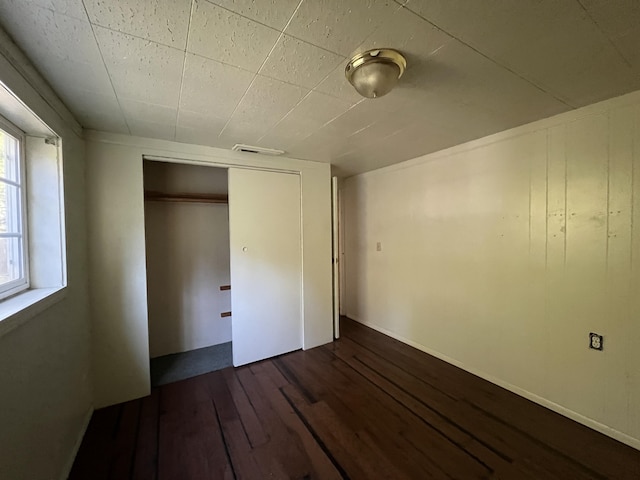 36770 Woods Ave, Burney, CA 96013 - unfurnished bedroom featuring dark wood-style flooring and a closet