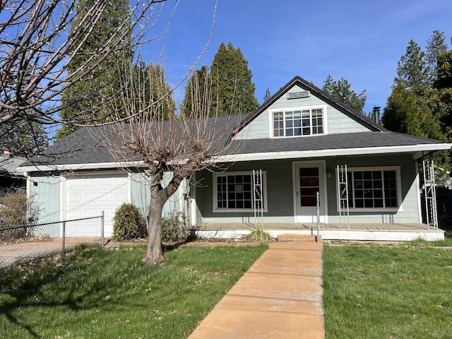 36770 Woods Ave, Burney, CA 96013 - view of front of home with an attached garage, covered porch, a front yard, and a shingled roof