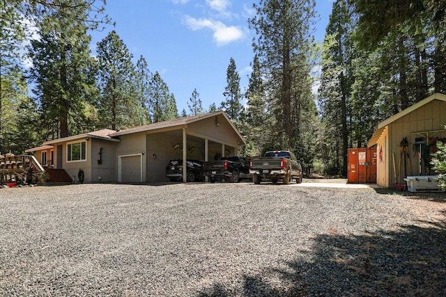 exterior space with gravel driveway and a garage