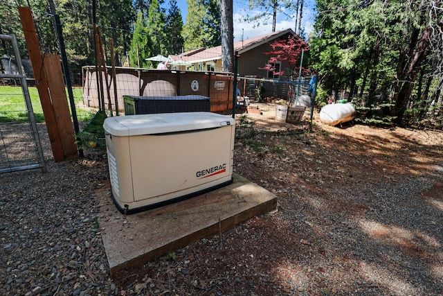 exterior details with fence, heating fuel, and a power unit