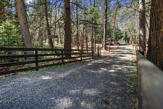 view of street featuring a forest view