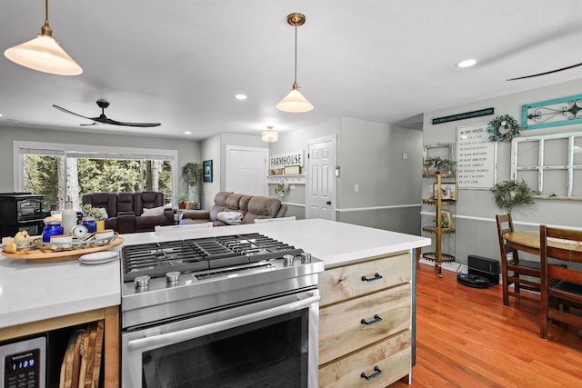 kitchen with light countertops, light wood finished floors, recessed lighting, and stainless steel range with gas stovetop