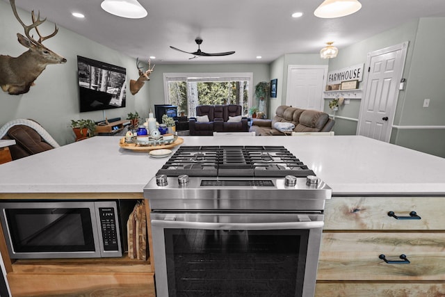 kitchen with recessed lighting, ceiling fan, open floor plan, and appliances with stainless steel finishes