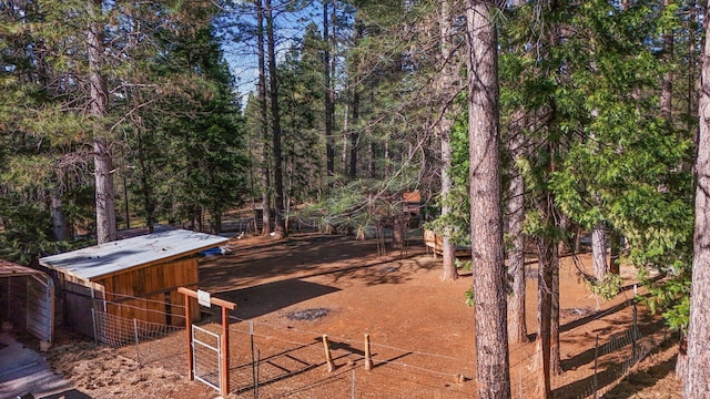 view of yard with fence, an outdoor structure, and an exterior structure