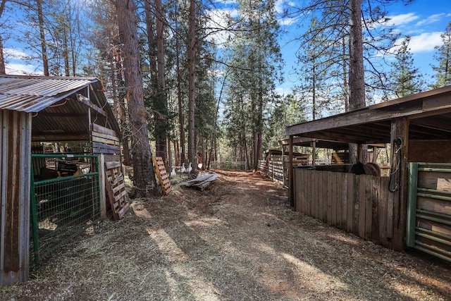 exterior space with metal roof, an exterior structure, and an outbuilding