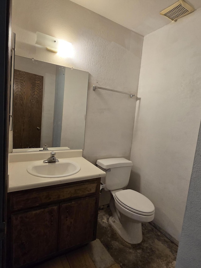 half bathroom featuring toilet and vanity