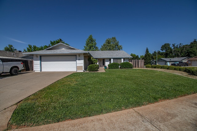 1695 Canter Ct, Redding, CA 96002 - single story home featuring a front yard, driveway, an attached garage, and fence