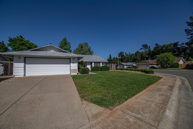 1695 Canter Ct, Redding, CA 96002 - single story home featuring concrete driveway, a garage, a front lawn, and fence