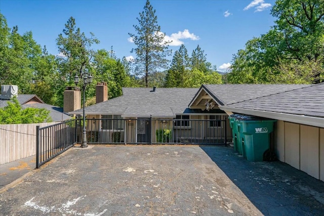 19817 Oak Knoll Dr, Lakehead, CA 96051 - view of front of house with fence, a chimney, driveway, and roof with shingles