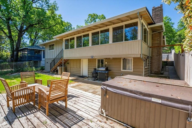 19817 Oak Knoll Dr, Lakehead, CA 96051 - back of house with a wooden deck, a hot tub, stairs, a chimney, and fence