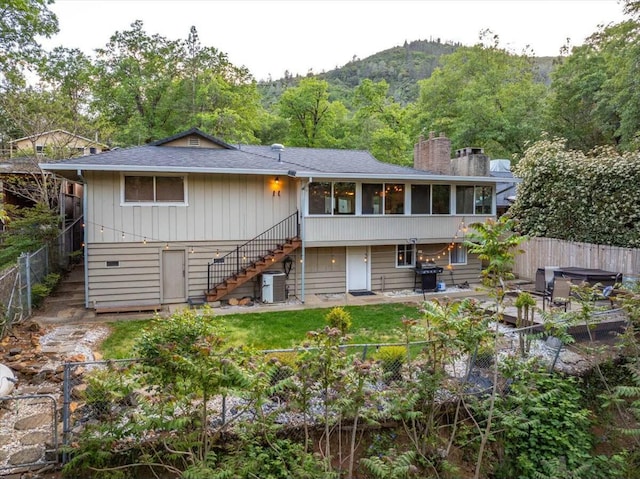 19817 Oak Knoll Dr, Lakehead, CA 96051 - rear view of property featuring stairway, a fenced backyard, central air condition unit, and a hot tub