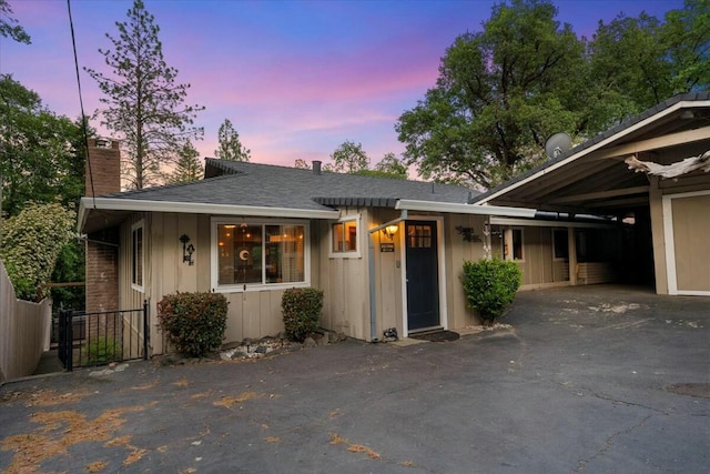 19817 Oak Knoll Dr, Lakehead, CA 96051 - ranch-style home featuring driveway, board and batten siding, a chimney, a shingled roof, and fence