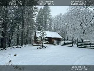 yard layered in snow with fence