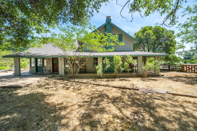 24294 Dersch Rd, Anderson, CA 96007 - back of property with a porch, a chimney, and fence