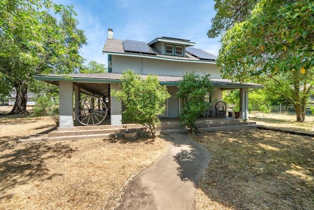 24294 Dersch Rd, Anderson, CA 96007 - view of front of property with covered porch, a chimney, stucco siding, roof mounted solar panels, and fence