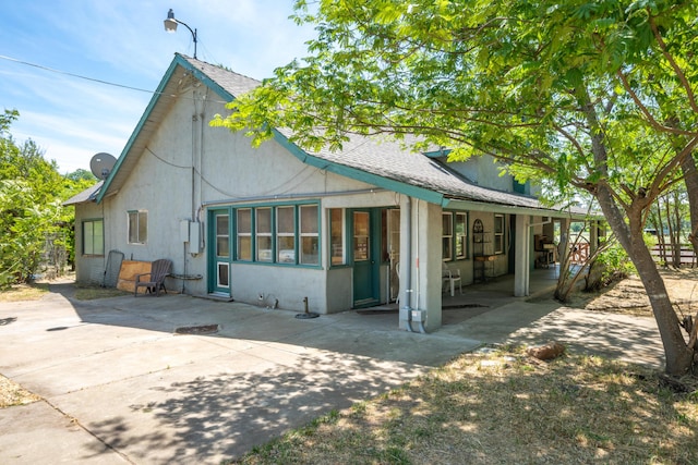24294 Dersch Rd, Anderson, CA 96007 - rear view of house featuring covered porch, roof with shingles, and stucco siding