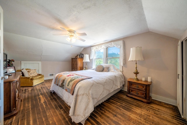 24294 Dersch Rd, Anderson, CA 96007 - bedroom featuring lofted ceiling, baseboards, dark wood-style flooring, a ceiling fan, and a textured ceiling