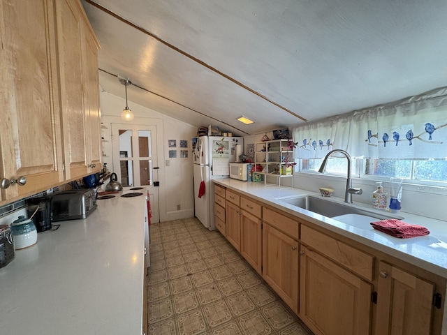 kitchen featuring white appliances, light floors, light countertops, vaulted ceiling, and a sink