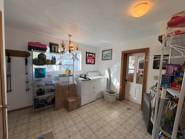 laundry room with an inviting chandelier, a textured ceiling, laundry area, and washing machine and dryer