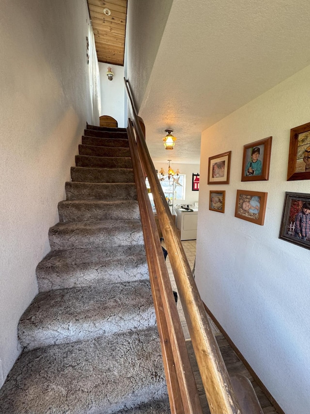 staircase featuring a textured wall