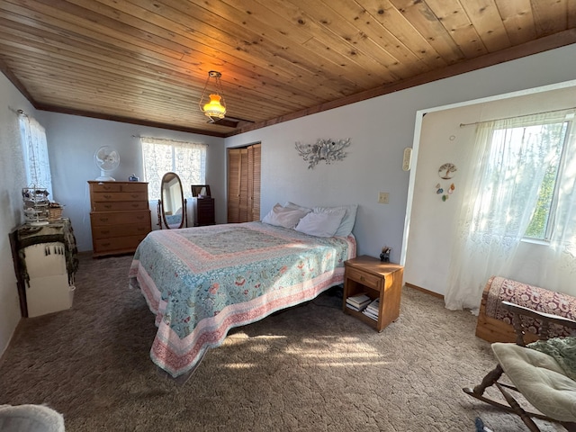 bedroom featuring a closet, wooden ceiling, and carpet floors