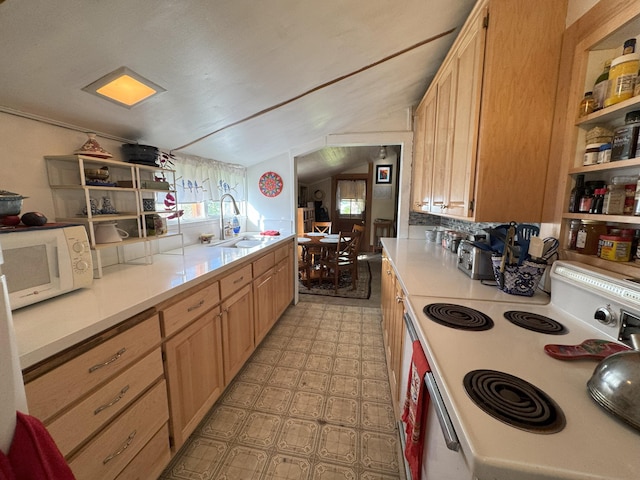 kitchen featuring light countertops, a sink, lofted ceiling, and white appliances