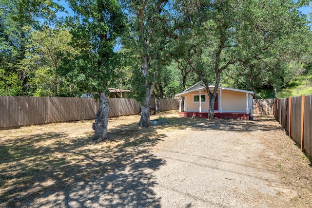 1390 Branstetter Ln, Redding, CA 96001 - view of yard featuring a fenced backyard, driveway, and a deck