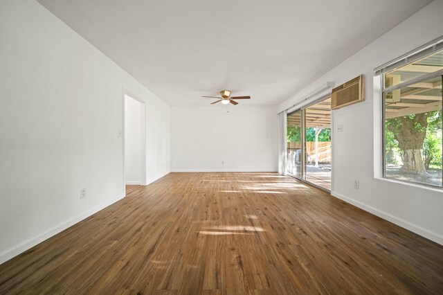 unfurnished room featuring baseboards, a ceiling fan, and hardwood / wood-style floors