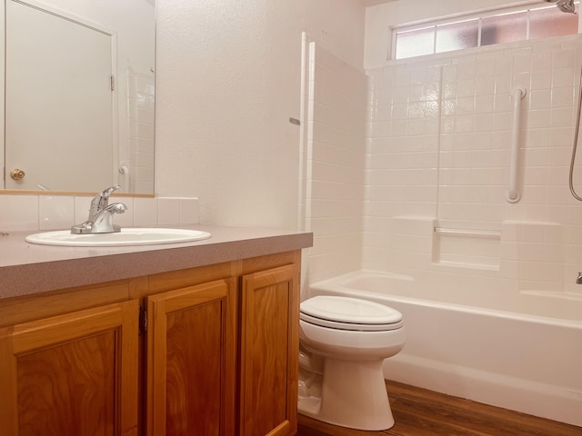 full bathroom featuring wood finished floors, toilet,  shower combination, and vanity