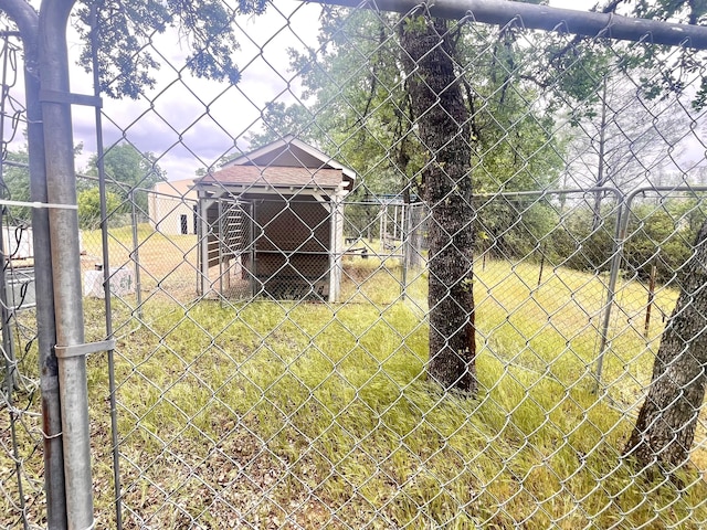 view of yard featuring an outdoor structure and fence