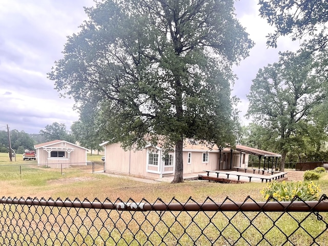 exterior space featuring a front yard and a fenced backyard