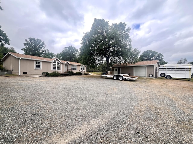 exterior space with gravel driveway and an attached garage